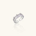 Silver-toned adjustable crown ring with channel-set square zirconia stones and delicate floral details on white background